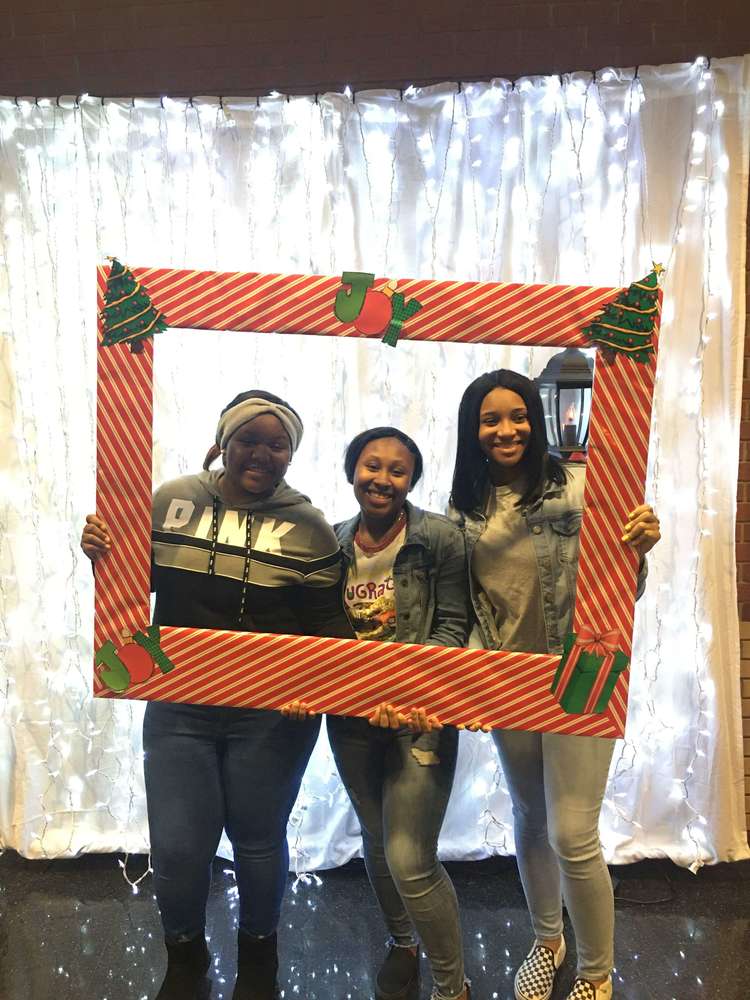 Students posing with picture frame prop