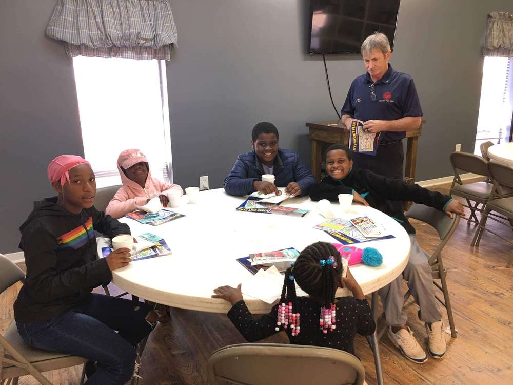 Kids at table with handouts