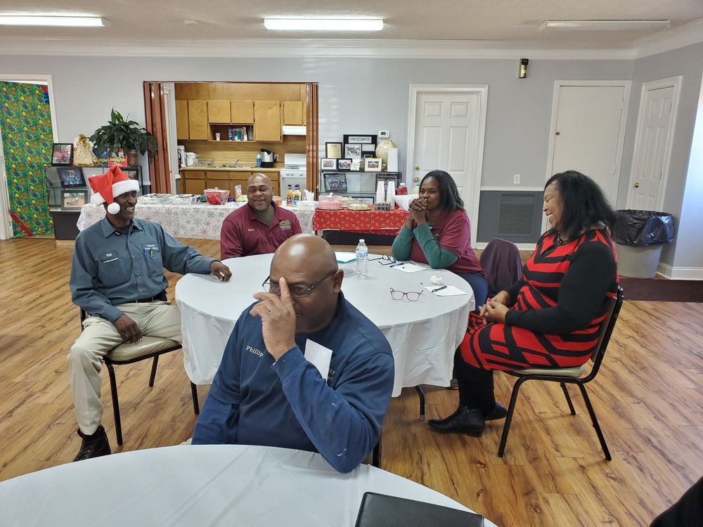 Staff talking around tables at workshop