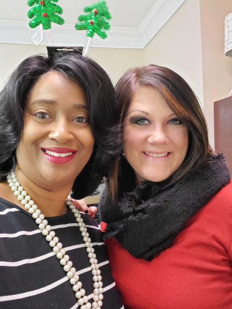 2 women from staff posing together