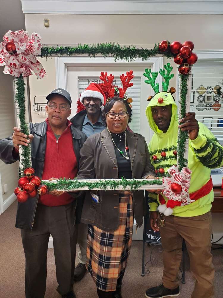 Four staff members with antlers and frame prop