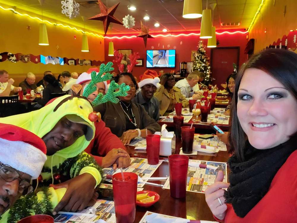 Group staff picture at restaurant, everyone looking down tables