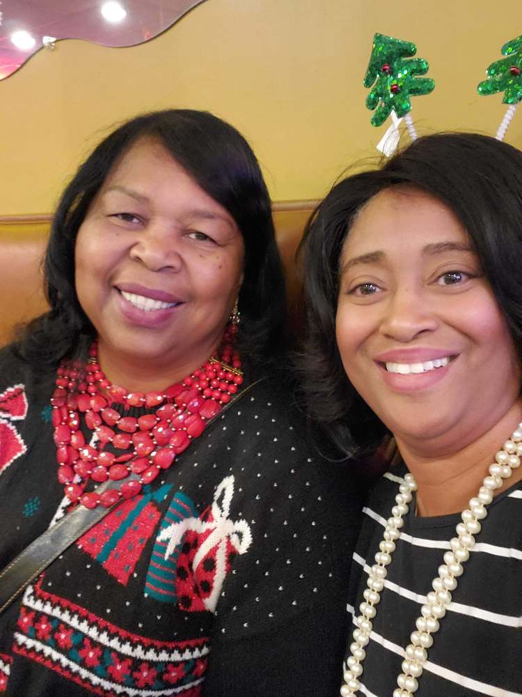 2 women from staff smiling for camera