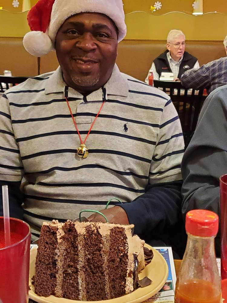Man from staff with large piece of cake