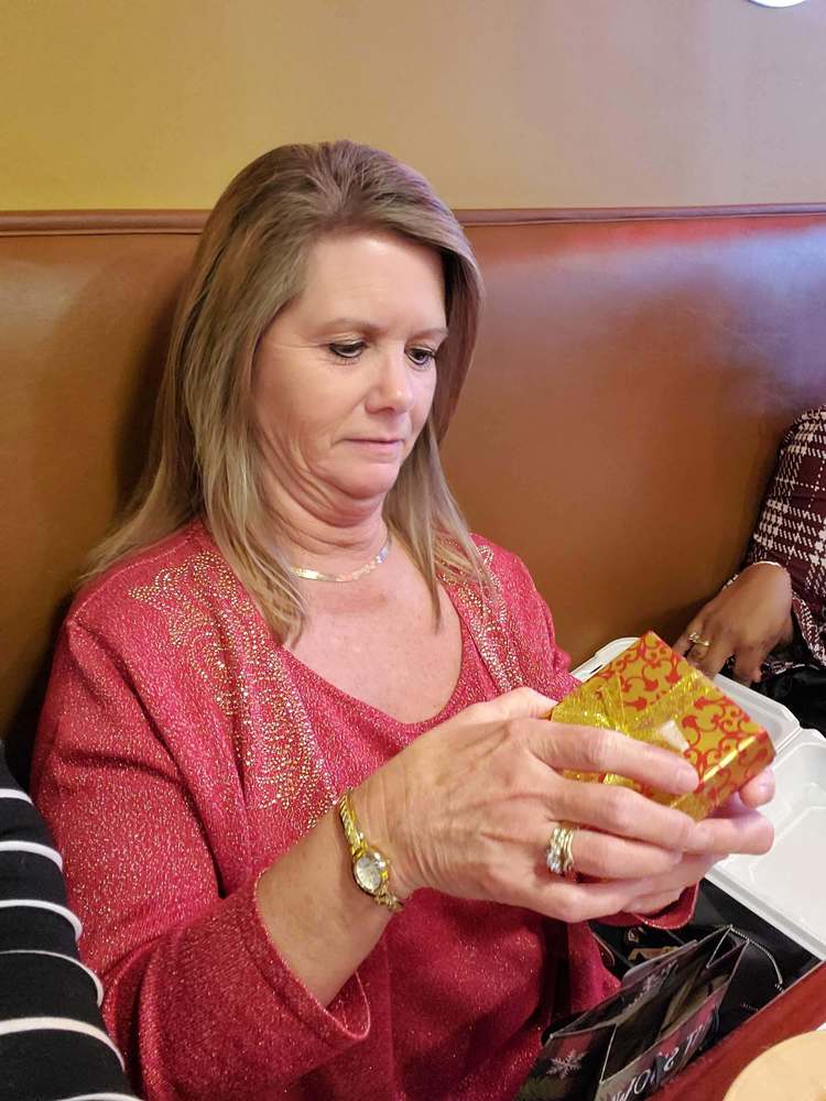 Woman opening palm sized box