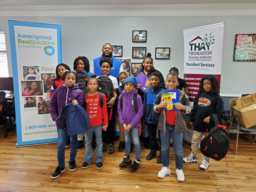 group photo of kids wearing their backpacks