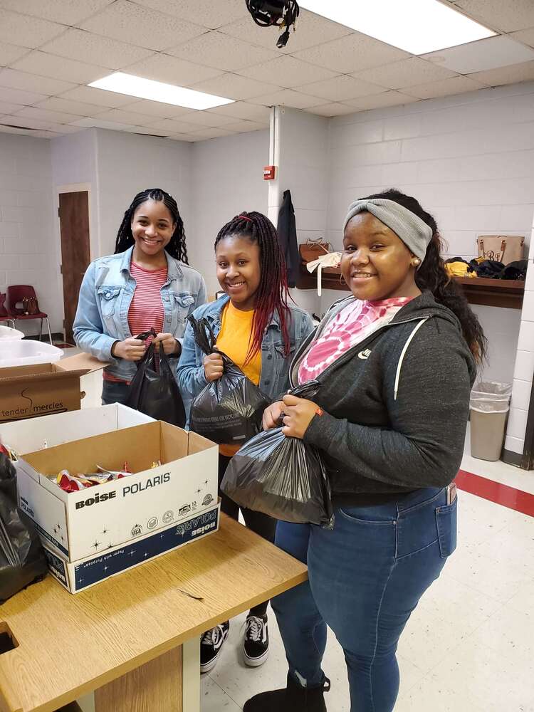 Volunteers packing take home meals