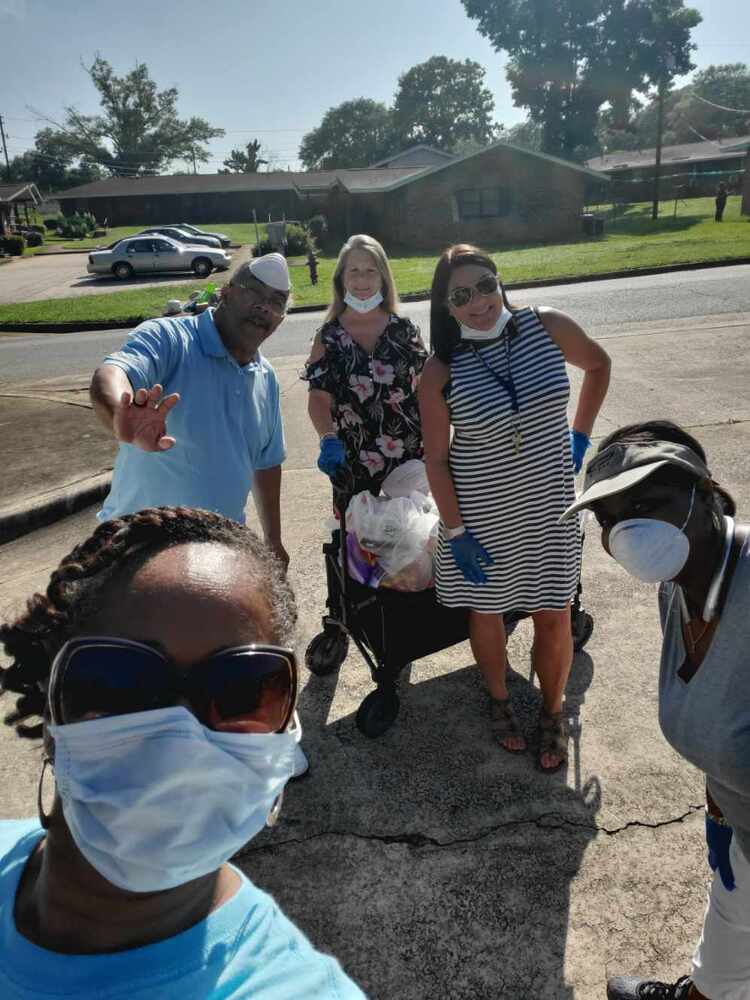 Staff group delivering safety packets to households