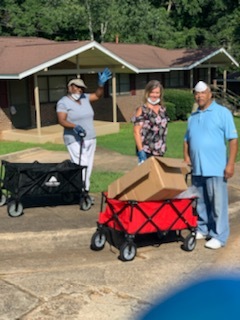 Staff with wagons of safety packets