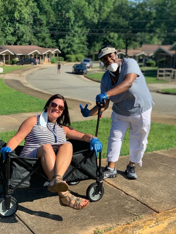 Staff member in wagon being pulled by another