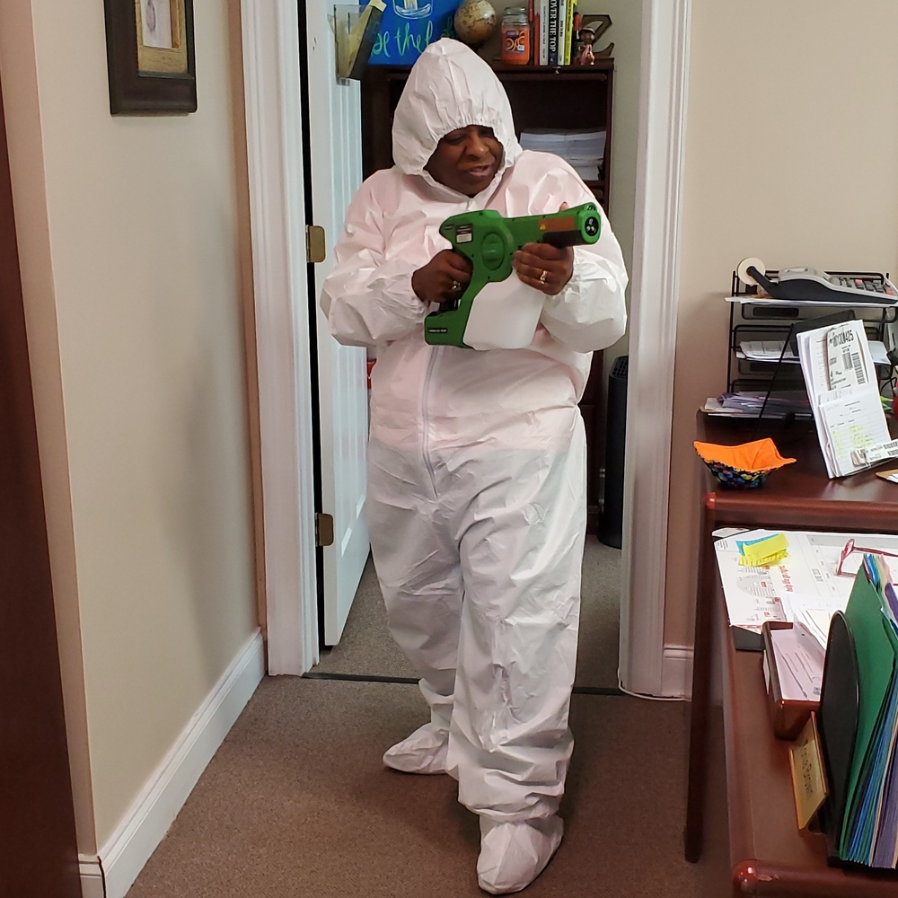 Staff member in white full body cover suit