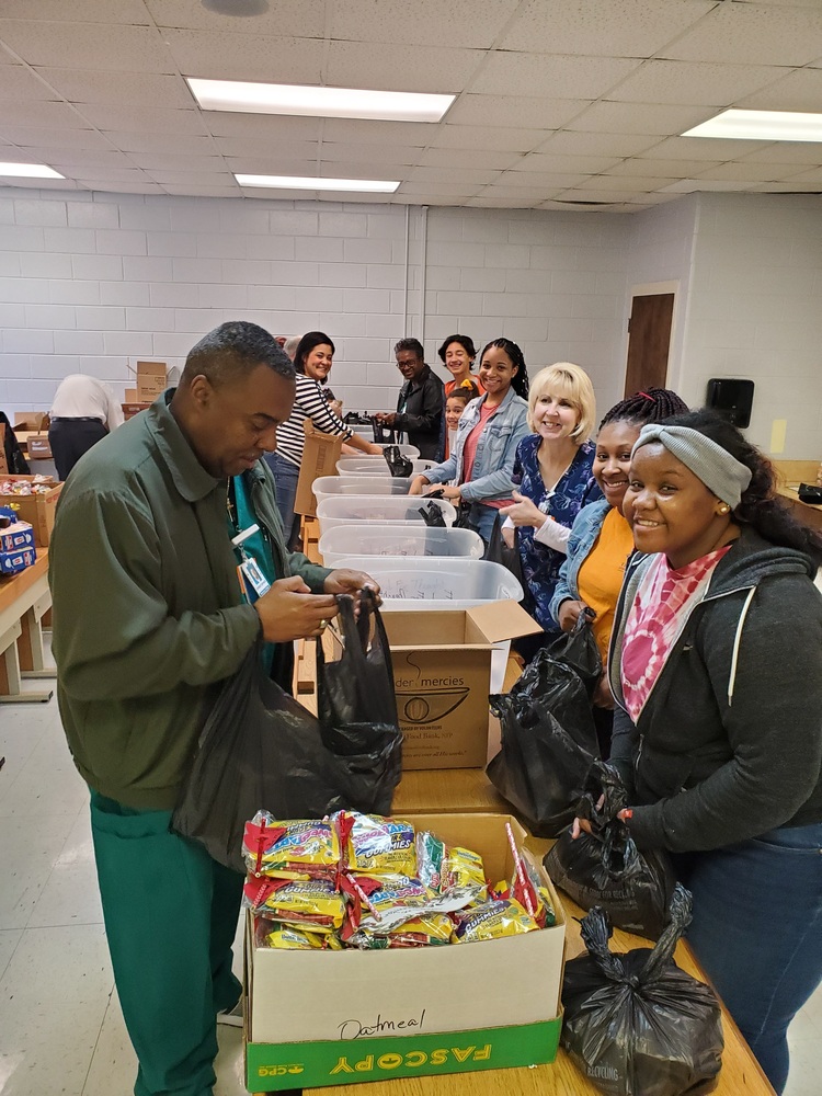 Students packing bags in an assembly line