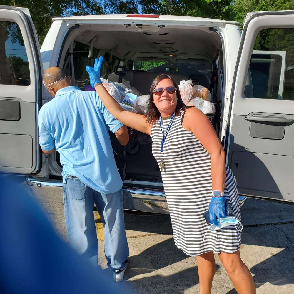 staff unloading food from van