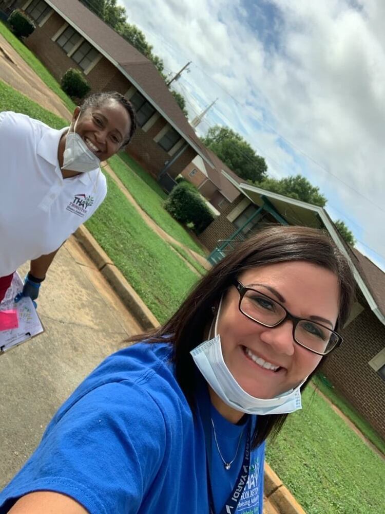 Two staff members taking selfie photo while delivering food