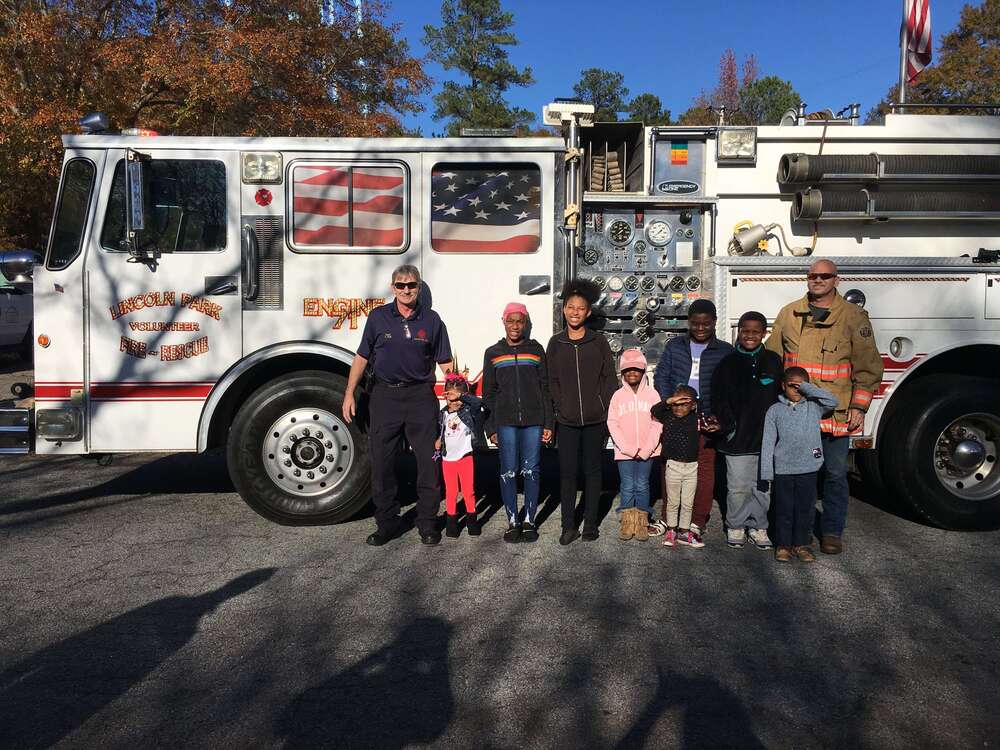 Group photo beside fire engine