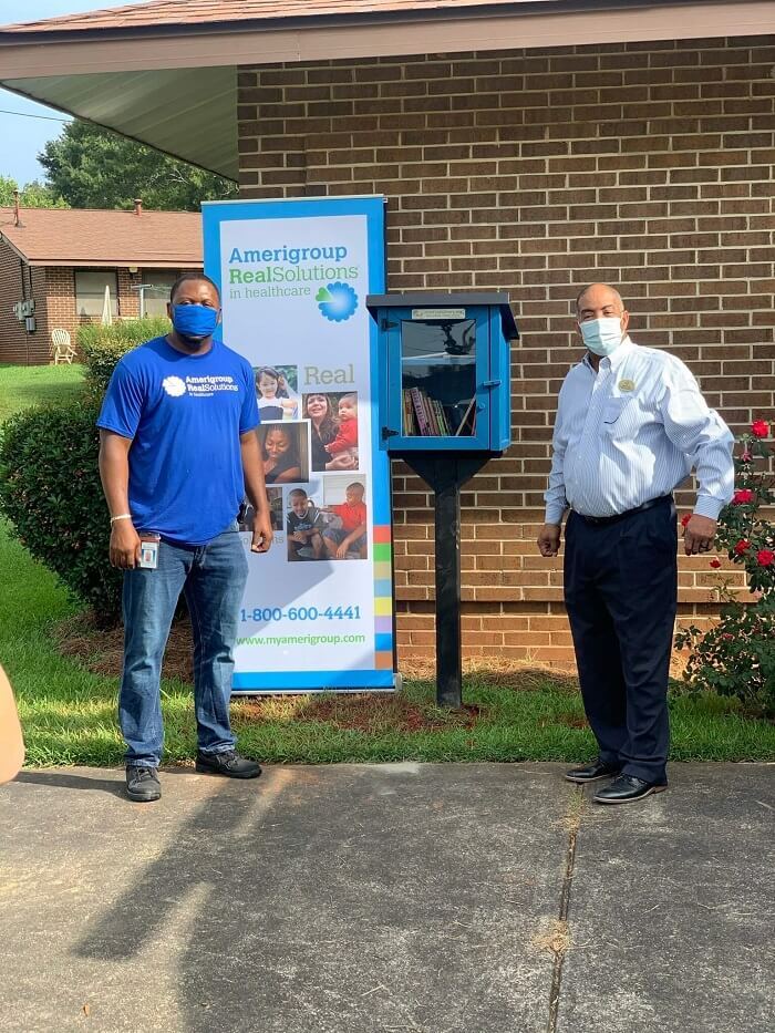 New Little library with Amerigroup banner and two people