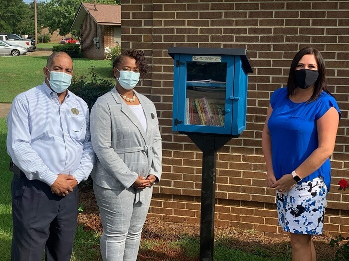 Group posing with new little library